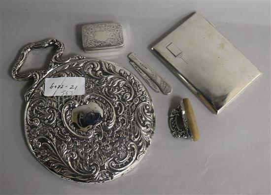 An Edwardian repousse silver hand mirror, a silver box, buffer, fruit knife and cigarette case.